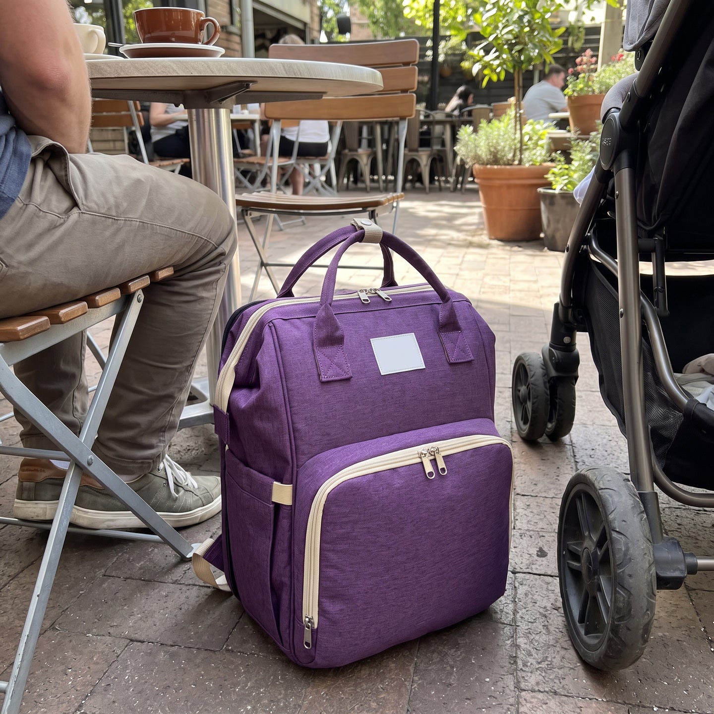 Backpack beside a spare baby outfit